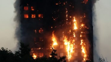 Flames rise from the Grenfell Tower building on fire in London where 72 people died.