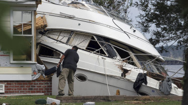 An insurance adjuster looks over a storm-beached yacht in North Carolina after Hurricane Florence came through on September 20. 