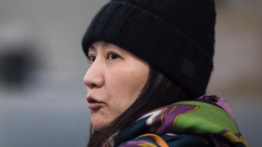 Huawei chief financial officer Meng Wanzhou talks with a member of her private security detail after they went into a wrong building while arriving at a parole office in Vancouver.