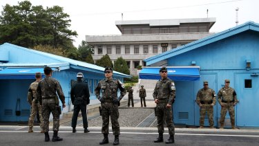 US and South Korean soldiers, foreground, and North Korean soldiers, background, stand guard in Paju, near Taesung in the DMZ, South Korea.