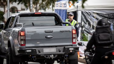 Police check cars for permits at the border checkpoint in Coolangatta at the Gold Coast on Friday, July 10.