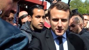 French President Emmanuel Macron, right, is flanked by his bodyguard, Alexandre Benalla, left background, at an outing in France in 2017.