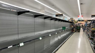 Empty toilet paper shelves at Woolworths on Sunday.