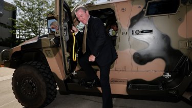 Then defence industry minister Christopher Pyne in a Hawkei earlier this year.