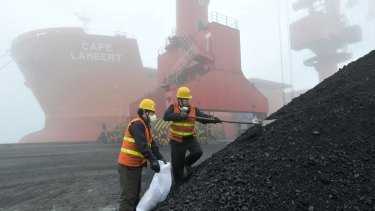Inspection and quarantine workers take samples of imported coal at a port in Rizhao in eastern China's Shandong province in 2010.