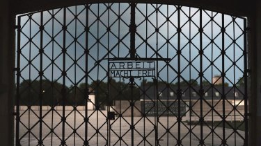 The entrance gate of the first Nazi concentration camp, Dachau, with the inscription 'Work sets you free' (Arbeit macht frei). 