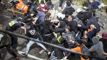 Protesters clash with Victoria Police officers at an anti-lockdown rally in Richmond.
