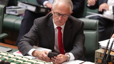 Former prime minister Malcolm Turnbull on his mobile phone.