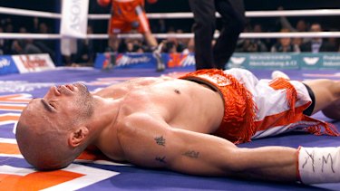 Mundine lies unconscious on the canvas after being knocked out by Sven Ottke in 2001.