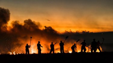Firefighters work on a wildfire on Winter Hill near Bolton, England.  Extreme temperatures, particularly warm ones, have again been prominent in 2018, on course to be one of the hottest years in history.
