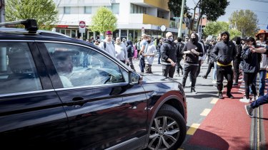 A lady in a vehicle bursts into tears as anti-lockdown protesters stop traffic in Richmond.