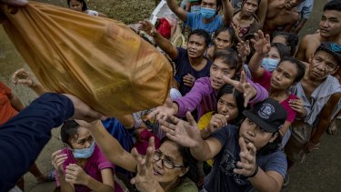 Residents affected by typhoon Vamco queue to receive relief goods in Tuguegarao, Philippines, in November.