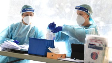 Healthcare workers are seen at a drive through pop up coronavirus testing facility in Clyde in Melbourne.