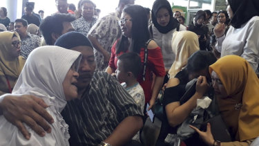 Relatives of passengers comfort each other at Depati Amir Airport in Pangkal Pinang as they wait for news on a Lion Air plane that crashed off Java Island.