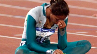 Australia's Cathy Freeman sits on the track after winning the women's 400m final at the Sydney Olympic Games.