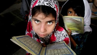 Girls reading in Karachi, Pakistan. 
 Australia's aid to Pakistan has focused on assisting women and girls.