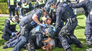 Police making an arrest after a scuffle with protestors.