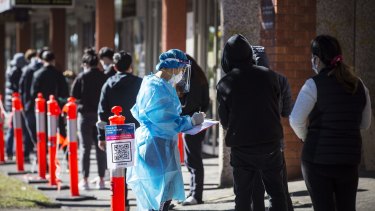 People queue down Ninth Street in Campsie to get tested.