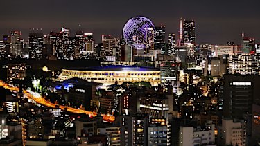 A drone display is seen over the top of the stadium during the Opening Ceremony.