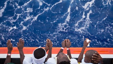 African migrants stand on the deck of the Aquarius.
