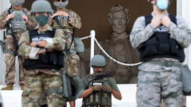 Members of the D.C. National Guard stand on the steps of the Lincoln Memorial monitoring demonstrators during a peaceful protest against police brutality and the death of George Floyd, on June 2 in Washington, DC. 