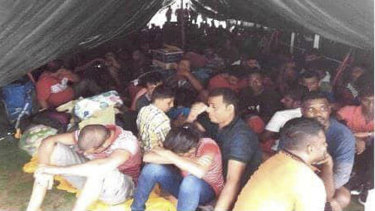 This photo, released by the Royal Malaysian Police, shows illegal migrants on a rusty tanker near Kota Tinggi in Johor state, Malaysia.