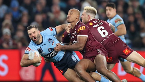 James Tedesco gets tackled. 