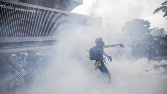 A protester stands in a cloud of tear gas during the protest in Hong Kong on Wednesday. 