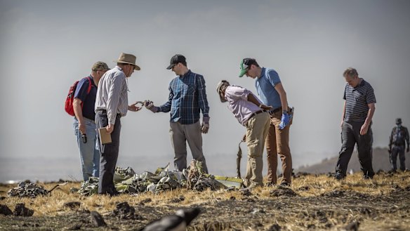 Foreign investigators examine wreckage at the scene where the Ethiopian Airlines Boeing 737 Max 8 crashed.