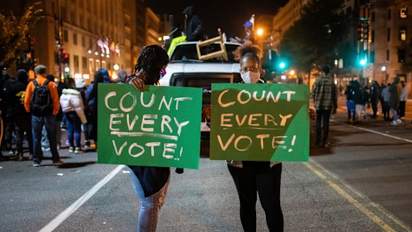 Demonstrators get their message across in Washington as the US waits for a result from the presidential election.