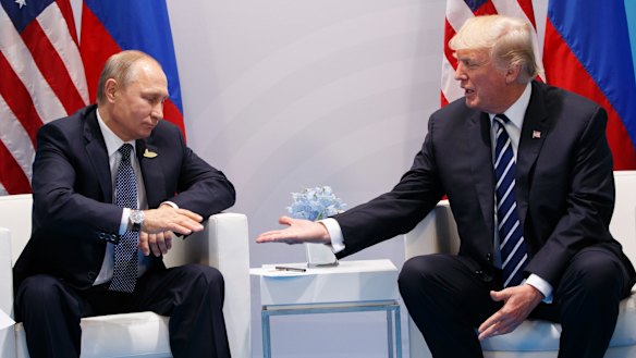 President Donald Trump reaches to shakes hands with Russian President Vladimir Putin at the 2017 G20 summit.