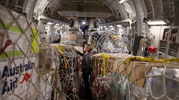 Former Foreign Affairs minister Julie Bishop inspects Australian aid supplies onboard a C17 bound for Vanuatu in 2015. A 2018 survey showed many Australians vastly overestimate the amount of aid Australia sends overseas.