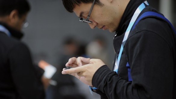A man checks his mobile phone.