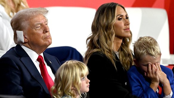 President-elect Donald Trump, sporting a bandage after his assassination attempt, with his grandchildren and Lara Trump at the Republican National Convention in July.
