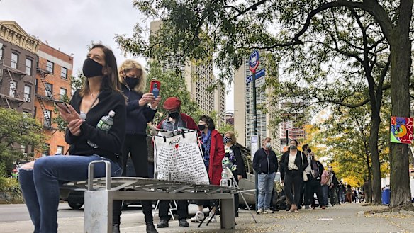 Voters wait in line for a Houston Street polling site on the first day of early voting.