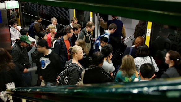 Commuters crowd to board a train at Town Hall.