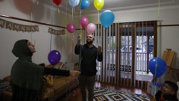 Omar and Sarah Dalati at home preparing for tomorrow's Eid celebrations with their children.