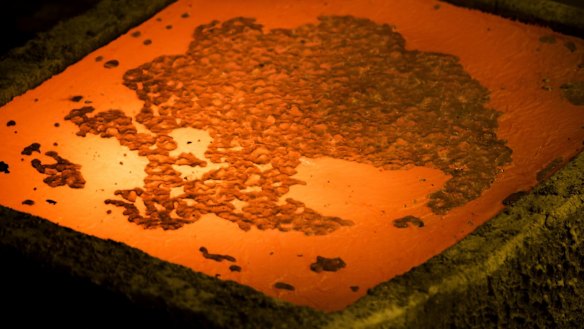 A red hot copper cathode sheet cools on a production line.