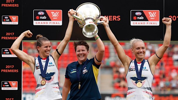 Chelsea Randall, Bec Goddard and Erin Phillip hold the cup aloft.