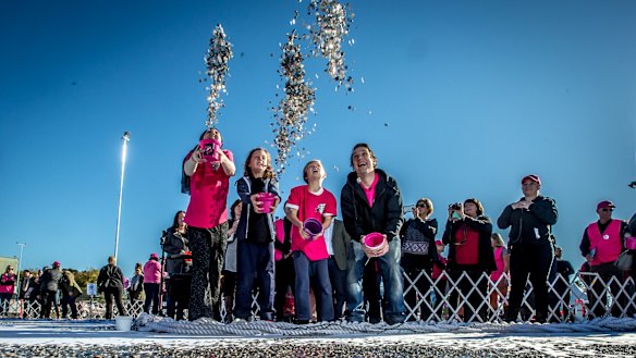 Connie Johnson, with sons Willoughby and Hamilton, and her brother Samuel Johnson toss in coins for the Big Heart Project in May last year.