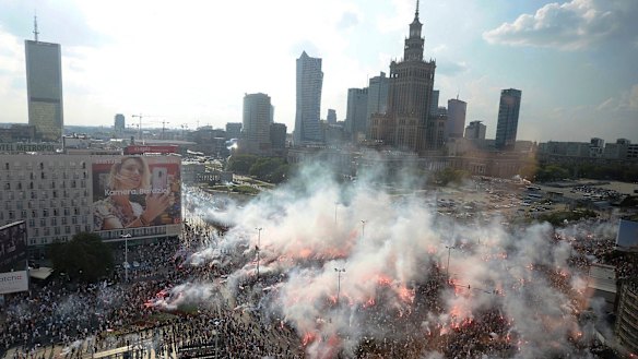 Warsaw residents stand with national flags and flares to observe a minute of silence for the fighters and victims of the 1944 Warsaw Rising against the Nazi German occupiers, on the 74th anniversary of the revolt last week.