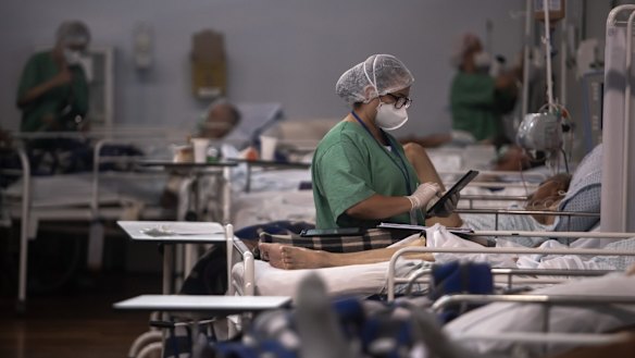 A healthcare worker treats a COVID-19 infected patient in Brazil.