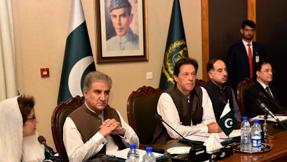 Pakistani Prime Minister Imran Khan, center, attends a briefing at the Foreign Ministry in Islamabad.