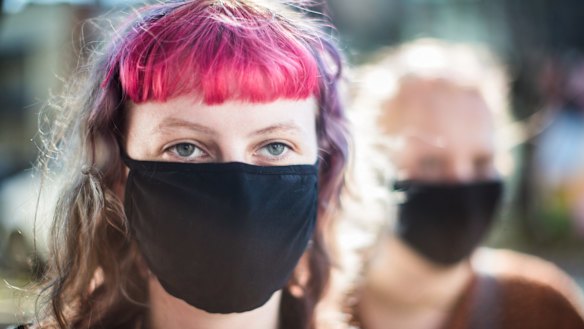 People wearing masks on Brunswick Street, Fitzroy, Melbourne.