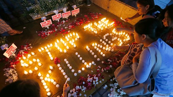 Human rights activists light candles in Quezon City for the victims of extra-judicial killings.