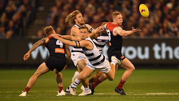 Players hunt the loose ball at the MCG.