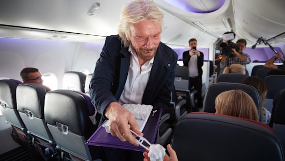Hot towel boy: Sir Richard Branson handing a towel to Social Seen.