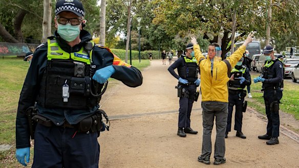 A man wearing a mask of Victorian Premier Daniel Andrews during an anti-lockdown rally in September.