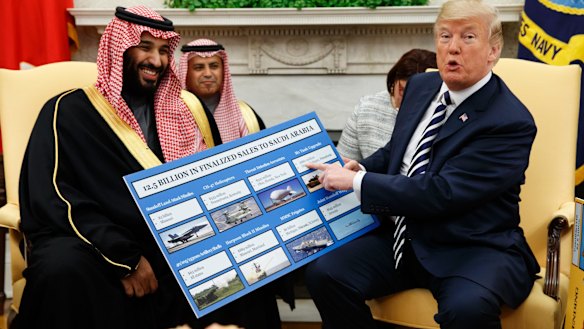US President Donald Trump shows a chart highlighting arms sales to Saudi Arabia during a meeting with Crown Prince Mohammed bin Salman in the Oval Office in 2018.