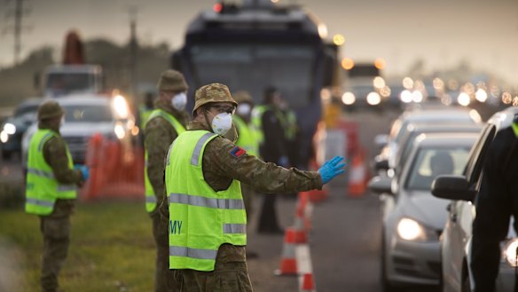 Soldiers help police at a roadside checkpoint on the Geelong Freeway as Melbourne went into lockdown in mid-July.